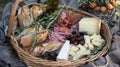 A basket filled with crusty bread artisan cheeses and cured meats makes for the perfect picnic charerie board