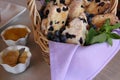 Basket filled with freshly baked blueberry scones, jams and jellies on the side