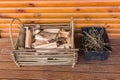 Basket Of Firewood And Twigs On Wooden Deck Background