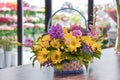 The basket of flowers. Arrangement of fresh flowers on the table. Flower shop. Flowers delivery on the house