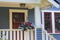 Basket of flowers on porch of a wooden house in Vancouver, British Columbia, Canada