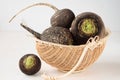 Basket with four black radishes Royalty Free Stock Photo