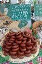 A basket of frankfurters or sausages at a farmers market