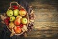 Basket with fresh apples and pears on a wooden table. Autumn background. Royalty Free Stock Photo