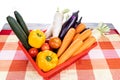 Basket of fresh assorted vegetables carrots, radish, capsicum, tomato, brinjal, cucumber