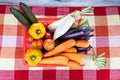 Basket of fresh assorted vegetables carrots, radish, capsicum, tomato, brinjal, cucumber