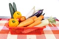 Basket of fresh assorted vegetables carrots, radish, capsicum, tomato, brinjal, cucumber