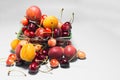 Basket of fresh fruit bananas, cherries, nectarines, apricots, peaches on a black and white background. Royalty Free Stock Photo