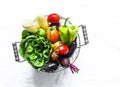Basket of fresh organic garden vegetables on a light background, top view. Copy space Royalty Free Stock Photo