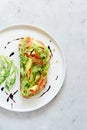 Basket with fresh organic greens, avocado and lime on a dark green background. Monochrome. Royalty Free Stock Photo