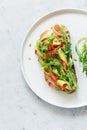 Basket with fresh organic greens, avocado and lime on a dark green background. Monochrome. Royalty Free Stock Photo