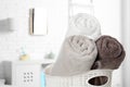 Basket with fresh rolled towels in bathroom