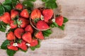Basket of fresh strawberries with leaves on vintage background Top view of ripe strawberry fruits