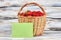 Basket of fresh strawberries on wooden background. Royalty Free Stock Photo