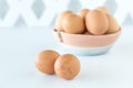 A basket of fresh whole free range eggs with two in front. Royalty Free Stock Photo