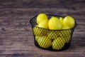Basket of fresh yellow lemons on a rustic wood table Royalty Free Stock Photo