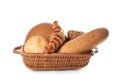 Basket with freshly baked bread products on white background Royalty Free Stock Photo