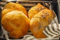 Basket of freshly baked dinner rolls with tableware in background. Macro with shallow dof Royalty Free Stock Photo