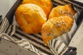 Basket of freshly baked dinner rolls with tableware in background. Macro with shallow dof Royalty Free Stock Photo