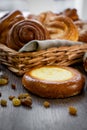 Basket of freshly baked dinner rolls with tableware in wooden background. Macro with shallow dof Royalty Free Stock Photo