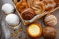 Basket of freshly baked dinner rolls with tableware in wooden background. Macro with shallow dof. Royalty Free Stock Photo