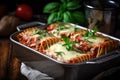 basket of freshly baked lasagna rollups, topped with melted mozzarella cheese Royalty Free Stock Photo