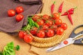 Basket of freshly picked cherry tomatoes and chilies with a pair of scissors beside them Royalty Free Stock Photo