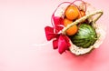 Basket with fruit on blue background. watermelon and oranges on pink pastel background Royalty Free Stock Photo