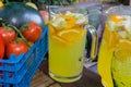 Basket of fruit with jug of orange squash.