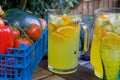 Basket of fruit with jug of orange squash.