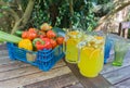 Basket of fruit with jug of orange squash.