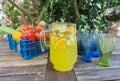 Basket of fruit with jug of orange squash.