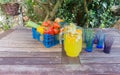 Basket of fruit with jug of orange squash.