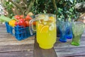 Basket of fruit with jug of orange squash.