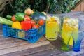 Basket of fruit with jug of orange squash.