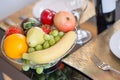 A basket of fruit on table set