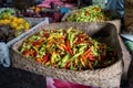 A basket full of fresh Indonesian chilli peppers, also called rawit or bird\'s eye chili