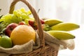 Basket full of fruits on a light background - high key Royalty Free Stock Photo