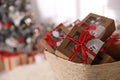 Basket full of gift boxes for Christmas advent calendar in room, space for text