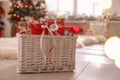 Basket full of gifts in paper bags for Christmas advent calendar at home, space for text