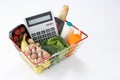 Basket full of groceries and calculator Royalty Free Stock Photo