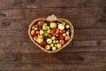 Basket full of ripe apples and pears on a wooden background. View from above. Flat lay. Copy space. Harvest concept Royalty Free Stock Photo
