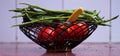 A basket full of vegitables and a knife