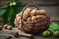 Basket full of walnuts. green and ripe walnuts, knife on wooden table