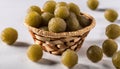 A basket of green olives on a white table