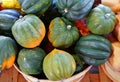 Basket of green and orange acorn squash in the fall