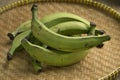 Basket with green unripe bananas