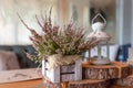 Basket with Heather on the table.heather in a basket . Autumn decorations.pink and purple flowers heather,heath in Royalty Free Stock Photo