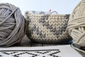 The basket is knitted from a thick cord of two colors. There are skeins of this cord next to it Royalty Free Stock Photo