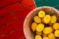 Clay pot basket of lemons on the coloful table with copyspace